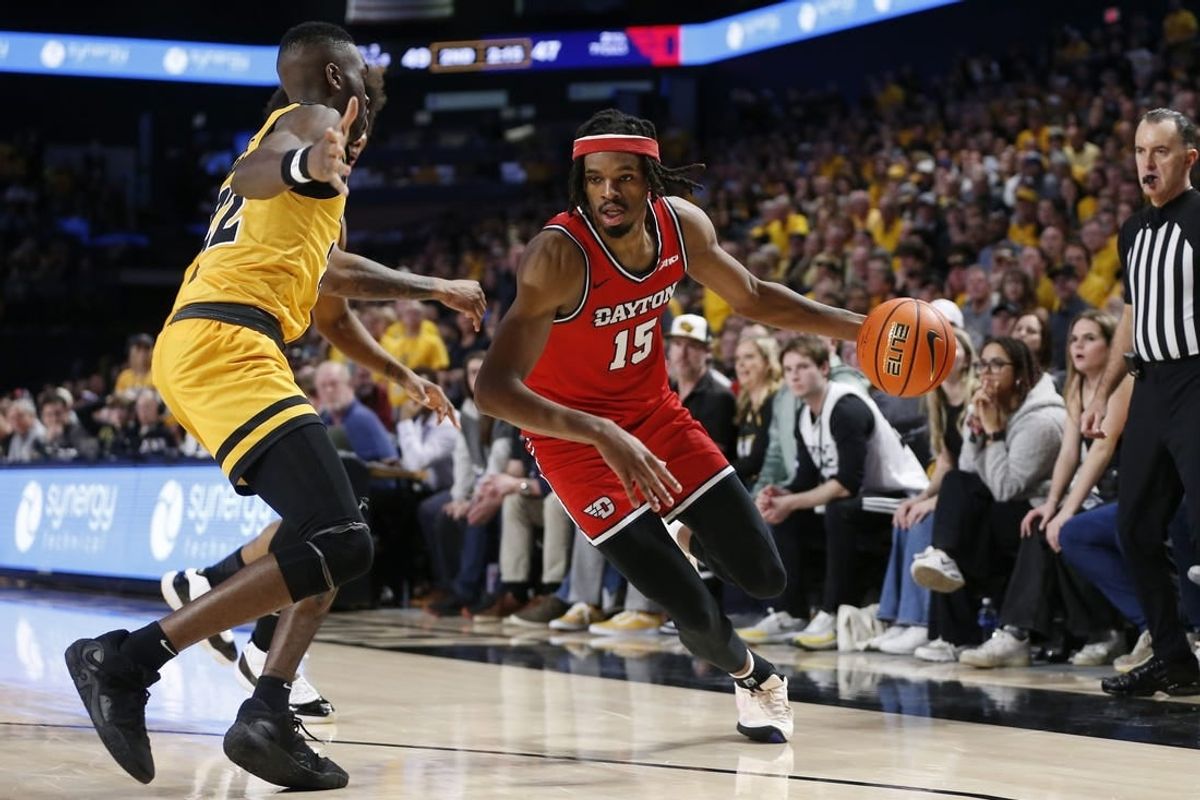 Feb 9, 2024; Richmond, Virginia, USA; Dayton Flyers forward DaRon Holmes II (15) controls the ball as Virginia Commonwealth Rams guard Joe Bamisile (22) defends during the second half at Stuart C. Siegel Center.