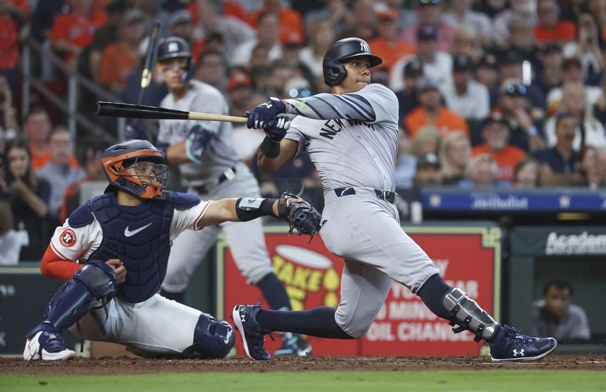 Mar 28, 2024; Houston, Texas, USA; New York Yankees right fielder Juan Soto (22) hits an RBI single during the fifth inning against the Houston Astros at Minute Maid Park.