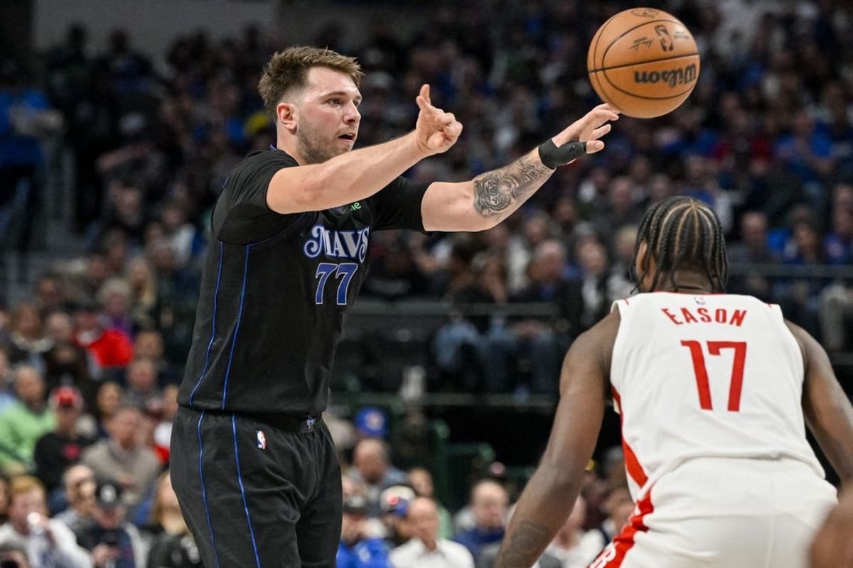 Nov 28, 2023; Dallas, Texas, USA; Dallas Mavericks guard Luka Doncic (77) passes the ball over Houston Rockets forward Tari Eason (17) during the second quarter at the American Airlines Center.