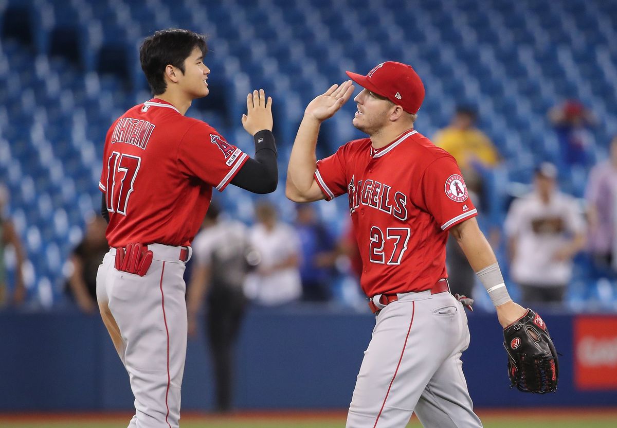 Under a plan proposed by MLB, superstars like Mike Trout (right) might earn only 44% of his prorated 2020 salary — over $35M — while teammate Shohei Ohtani (l.) would get more than 90% of his  roughly $700,000 salary .