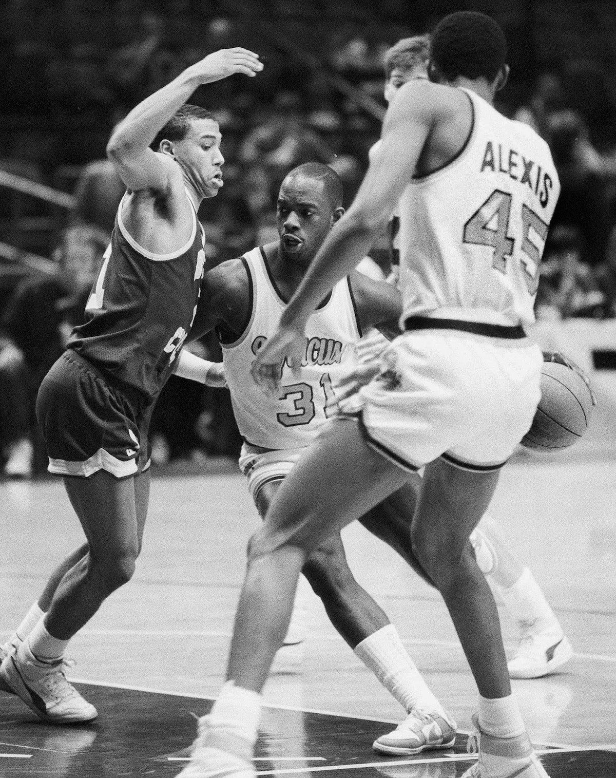 Dwayne “Pearl” Washington of Syracuse drives around Dana Barros of Boston College during the 1986 Big East tournament at Madison Square Garden. Via  [object Object] .