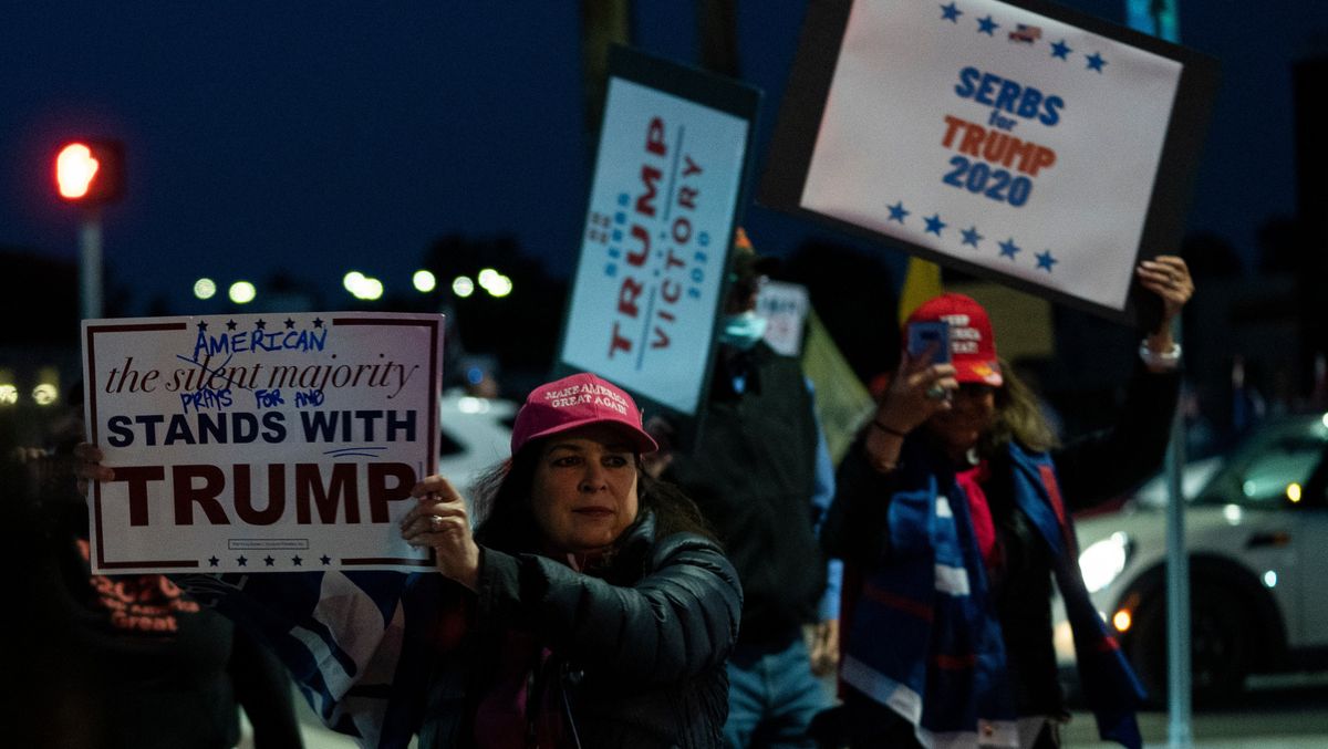 A group of unmasked protestors gather outside Walter Reed medical center to wish Donald Trump well, because nothing makes sense in this idiocracy anymore.