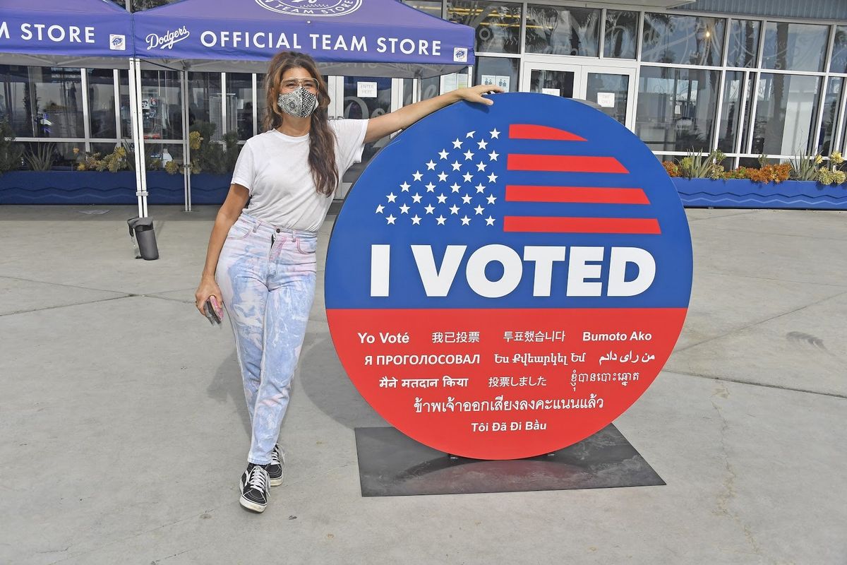 Mona Lisa Vito, aka Oscar winner Marisa Tomei, greets early voters at Dodgers Stadium.