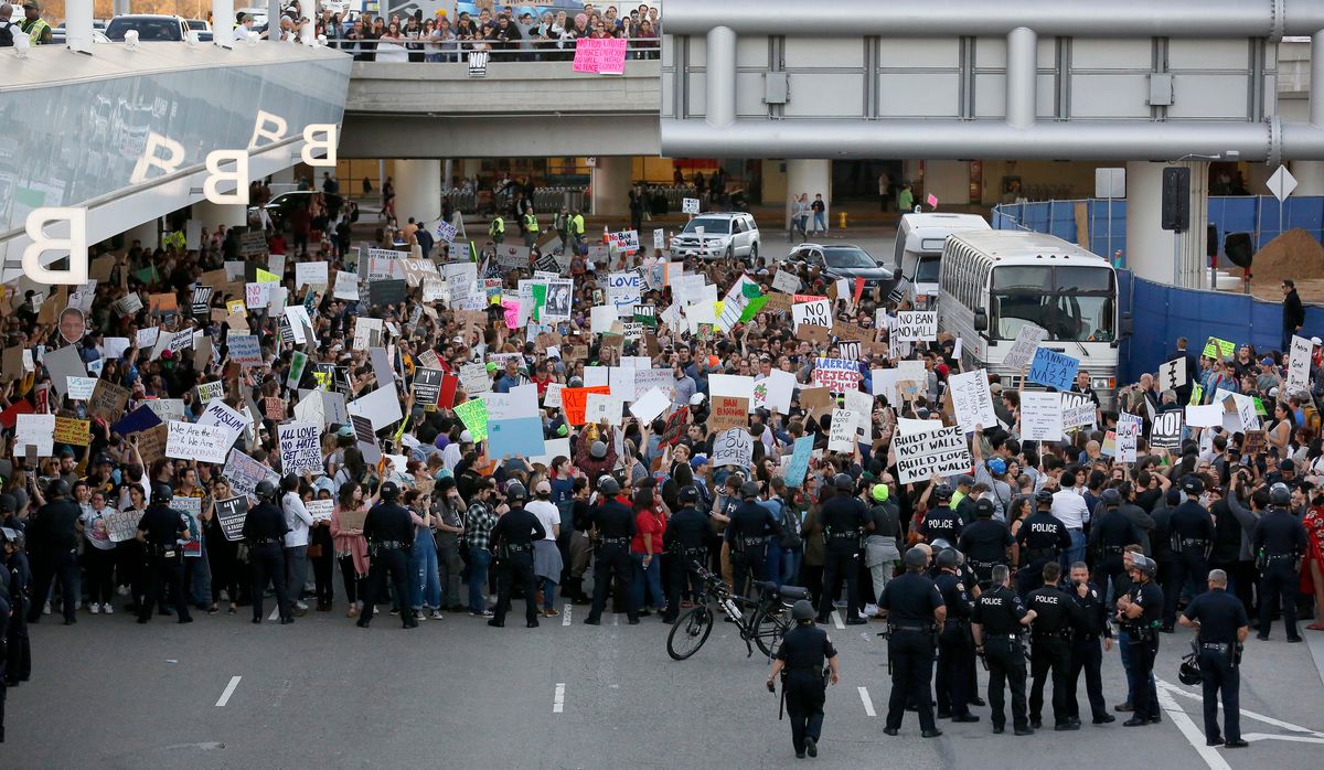 Protestors outside Los Angeles International airport on Sunday (Ryan Kang/ [object Object] )