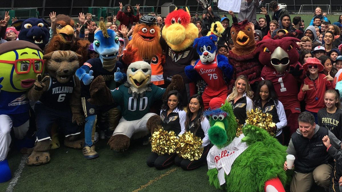 A group of mascots pose for a photo on the Friends Select school’s roof.