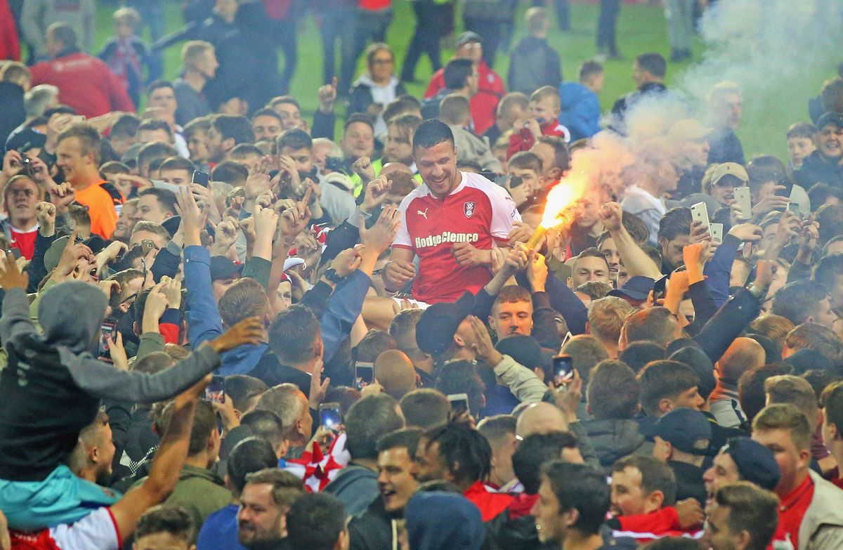 Richard Wood of Rotherham United is carried by fans  after a win back in 2018, but how long  can lower-league teams survive without folks i n stands ?