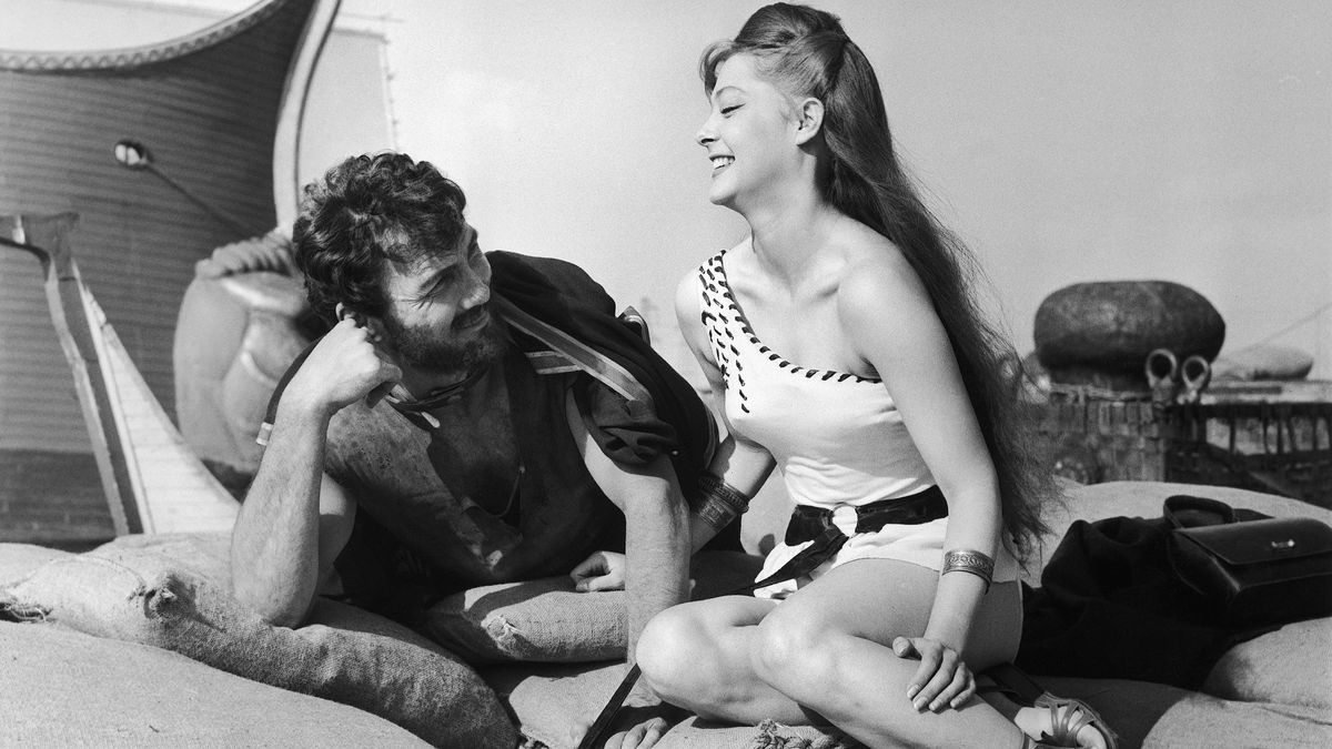 Well-known barbarian Jack Palance and Melody O’Brien enjoy a laugh while filming the documentary “Revak the Rebel.” Photo credit: Jim Pringle/ [object Object]