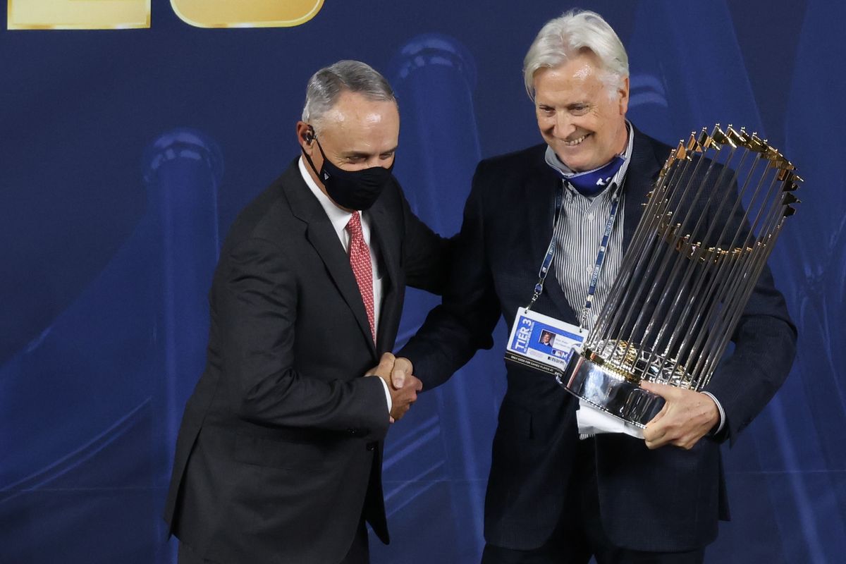 MLB Commissioner Rob Manfred presents the Commissioner’s Trophy to owner Mark Walter of the Los Angeles Dodgers Tuesday night.