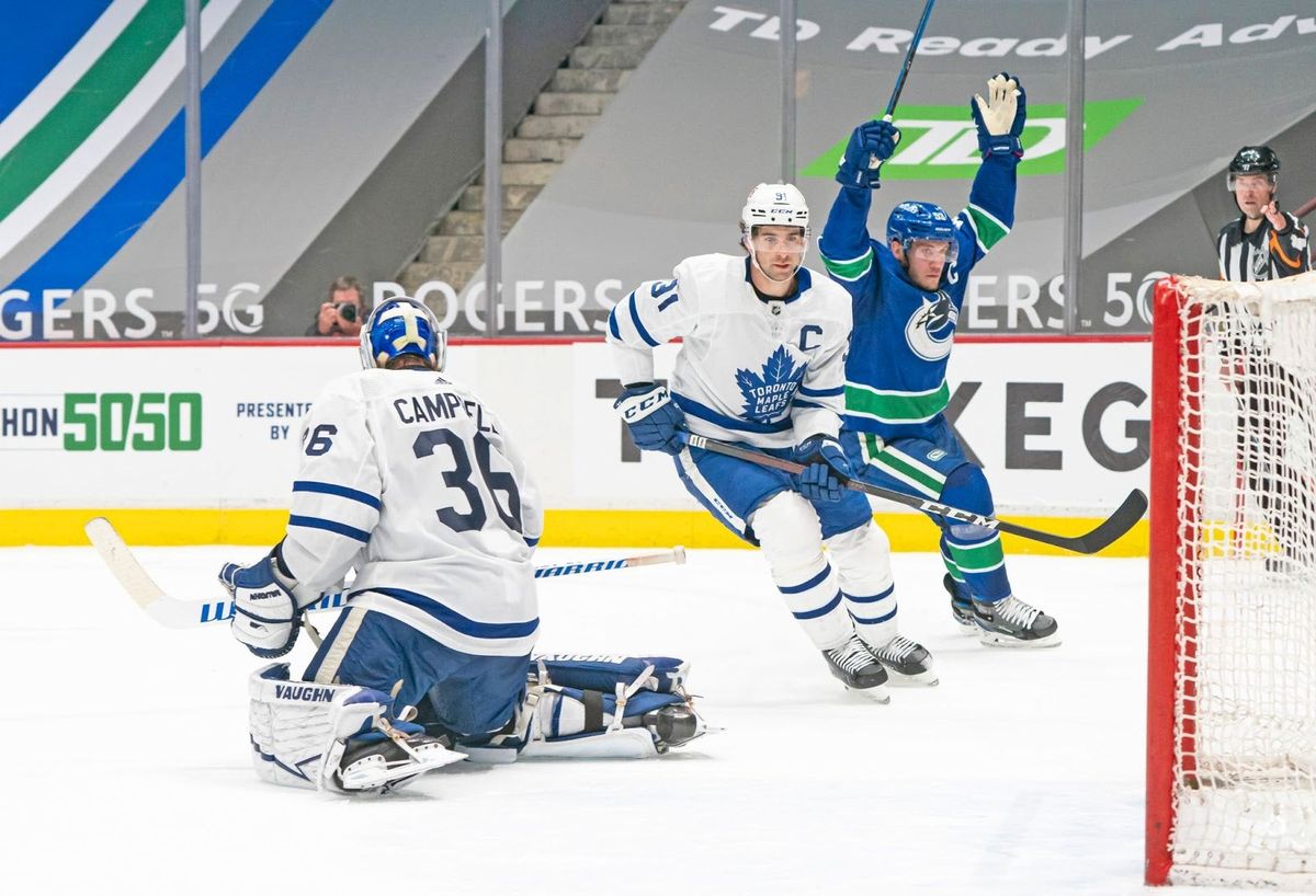 Bo Horvat (r.) celebrates after a game-winner against the Leafs.
