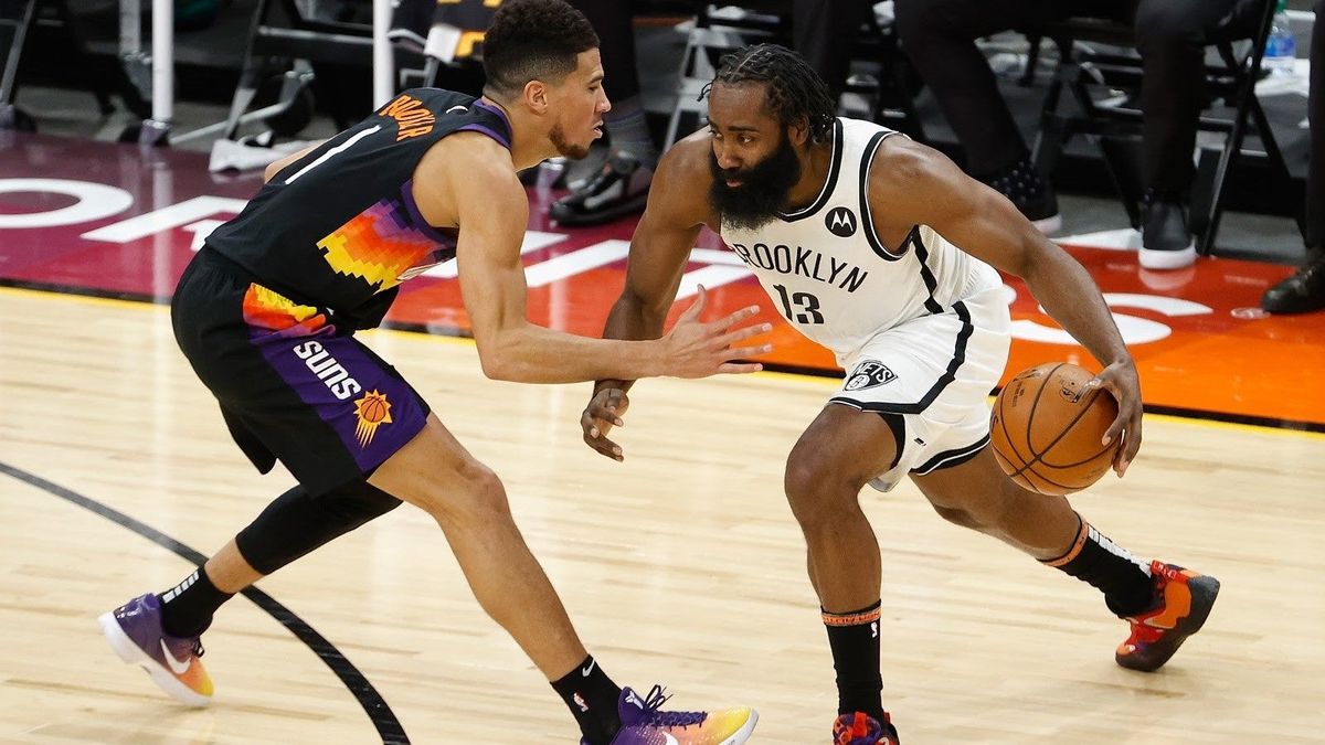 Phoenix’s Devin Booker guards Brooklyn’s James Harden in the Nets’ 128-124 come-from-behind victory Tuesday Night.