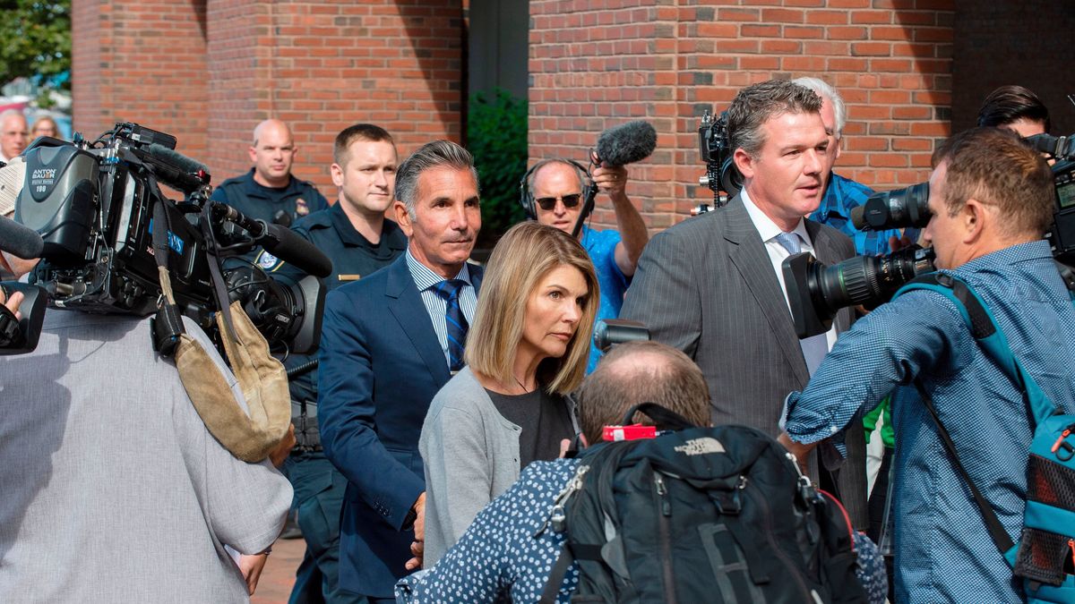 Lori Loughlin and husband Mossimo Giannulli exit a Boston federal courthouse after a pre trial hearing last year.