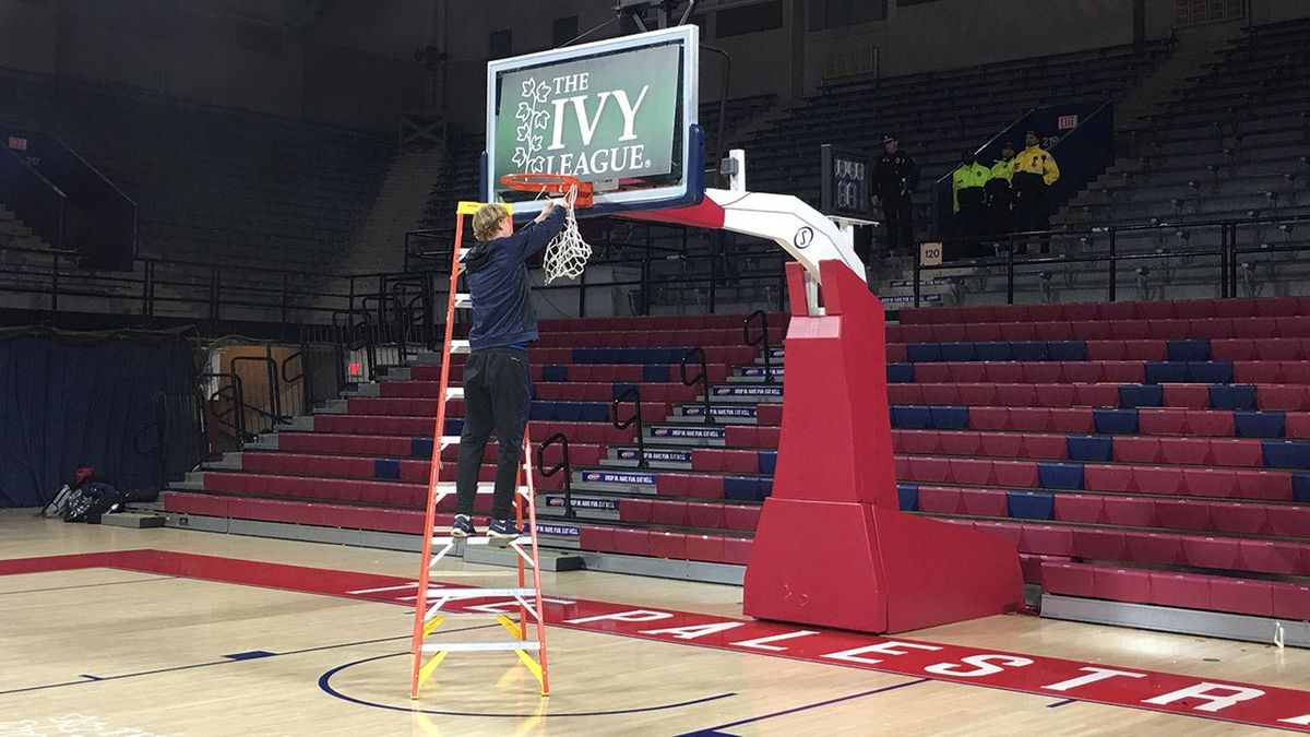 Penn senior Sam Jones cuts down the nets at The Palestra early Sunday morning.