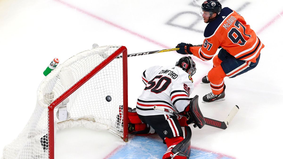 Connor McDavid #97 of the Edmonton Oilers scores his second goal against Corey Crawford #50 of the Chicago Blackhawks.