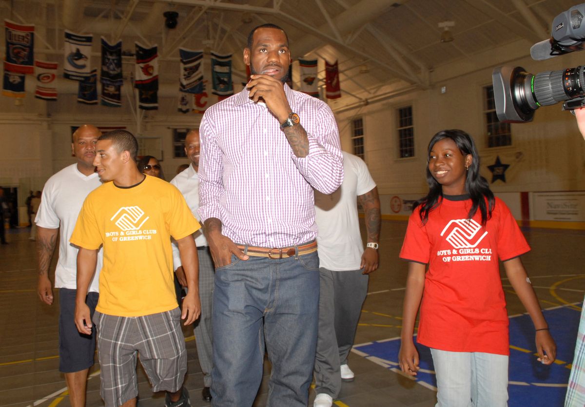 LeBron James is escorted into the Boys and Girls Club of Greenwich back on July 8, 2010, with Club members Camryn Ferrara and Sophia Lewis.