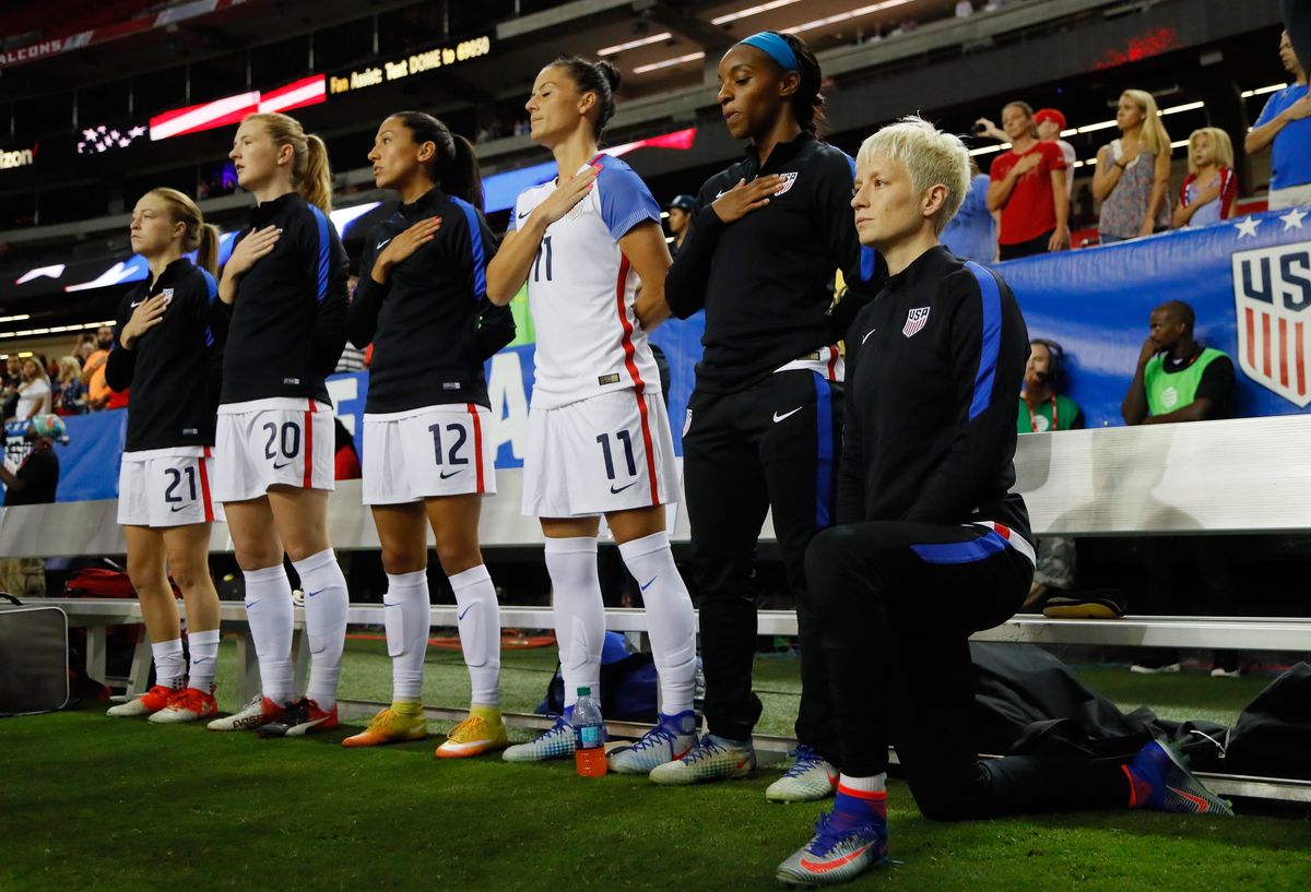 Megan Rapinoe kneels during the national anthem before game in 2016. U.S. Soccer overturned a rule requiring players to stand for the anthem.