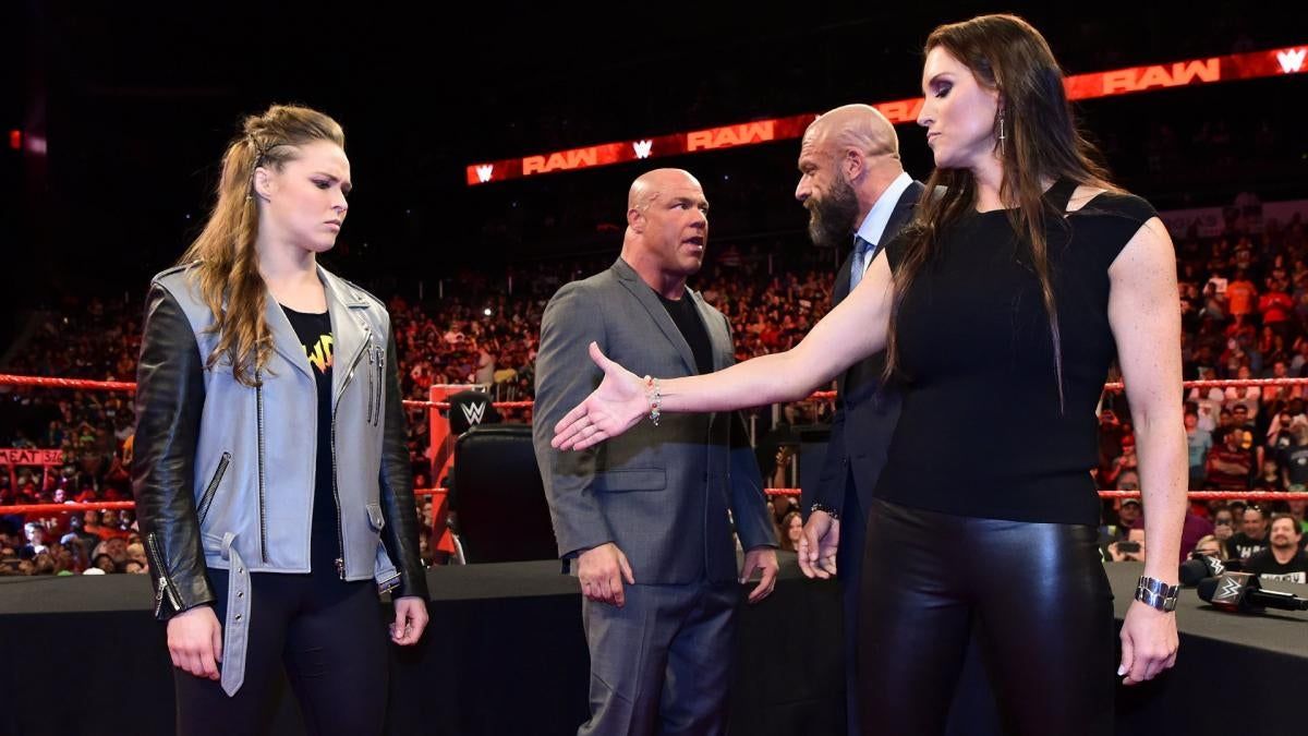 Ronda Rousey, Kurt Angle, Triple H, and Stephanie McMahon.