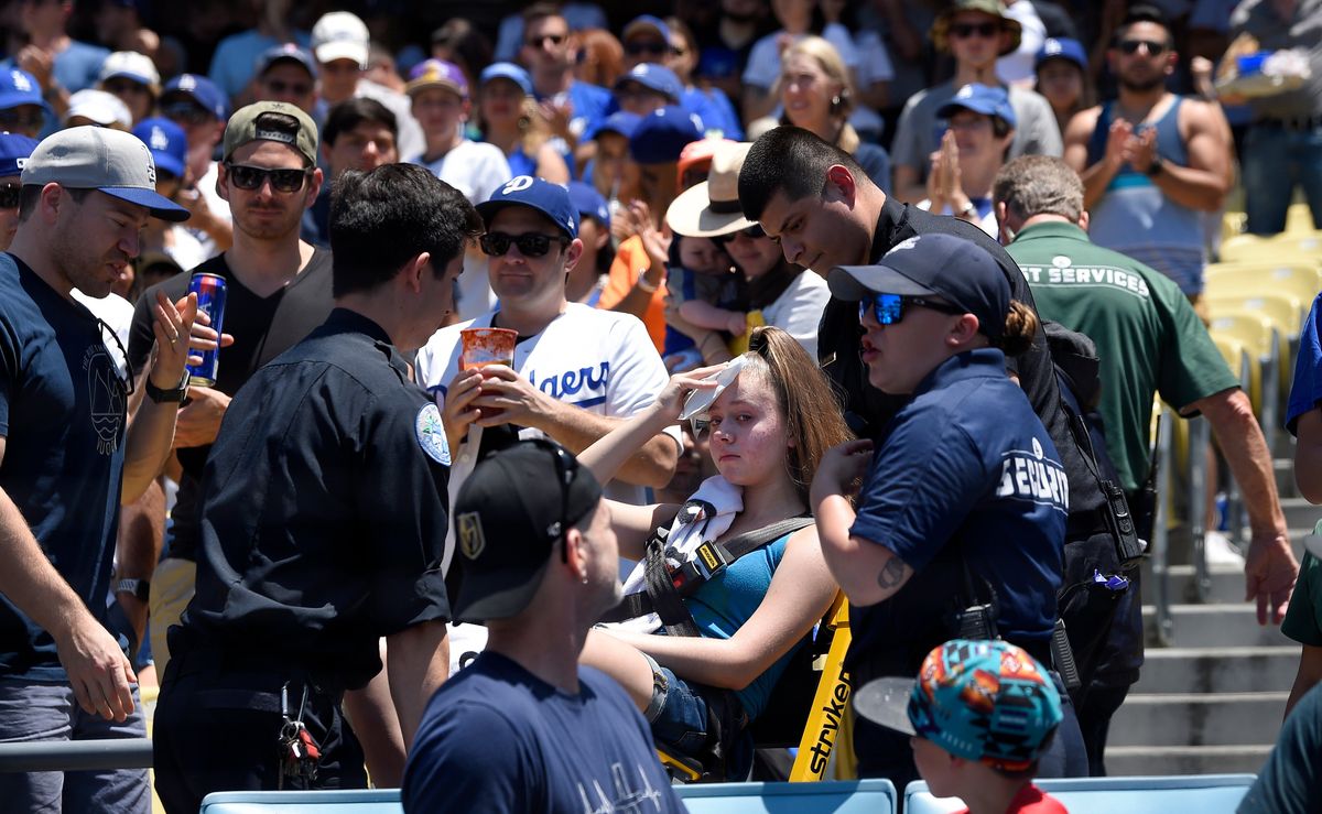 A young fan is carted away after being hit with a foul ball hit by Los Angeles Dodgers’ Cody Bellinger during the first inning of a baseball game against the Colorado Rockies, Sunday, June 23, 2019, in Los Angeles.