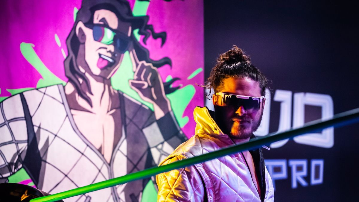“Bad Boy” Joey Janela, flanked by his comic book-style banner, prepares for action in the titular dojo.