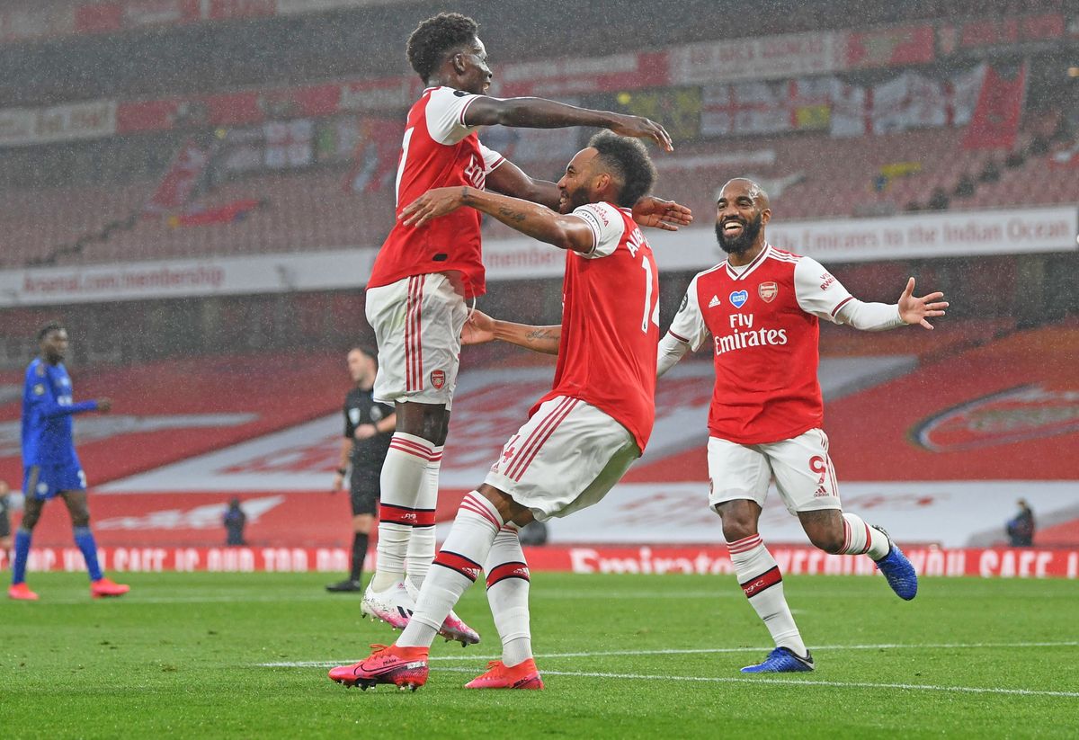Pierre-Emerick Aubameyang of Arsenal celebrates with teammates Bukayo Saka and Alexandre Lacazette after scoring his team’s first goal during the Premier League match between Arsenal FC and Leicester City.