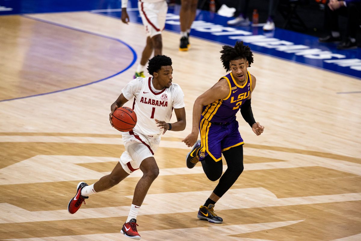 Herbert Jones #1 of Alabama dribbles across half court against Trendon Watford #2 of LSU during the second half of their championship game in the SEC Men’s Basketball Tournament at Bridgestone Arena on March 14, 2021 in Nashville,