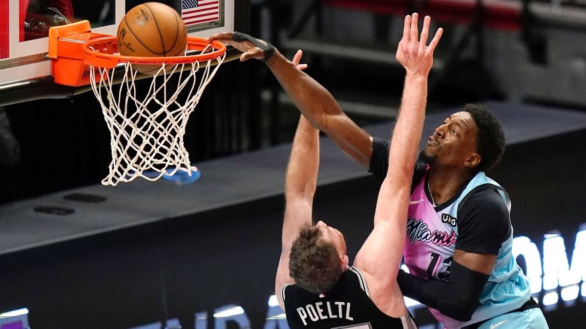 Miami Heat center Bam Adebayo dunks over San Antonio Spurs center Jakob Poeltl during the second half last night.
