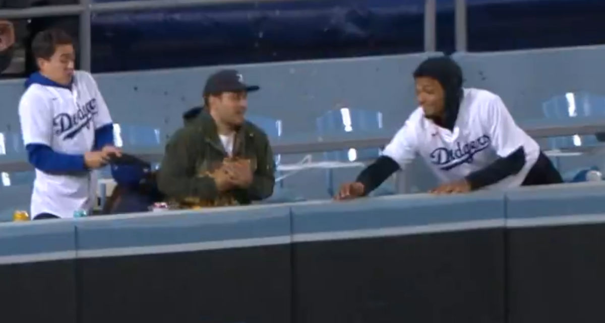 This ‘lucky fa n” lost his  nachos  but got a home ru n  ball.