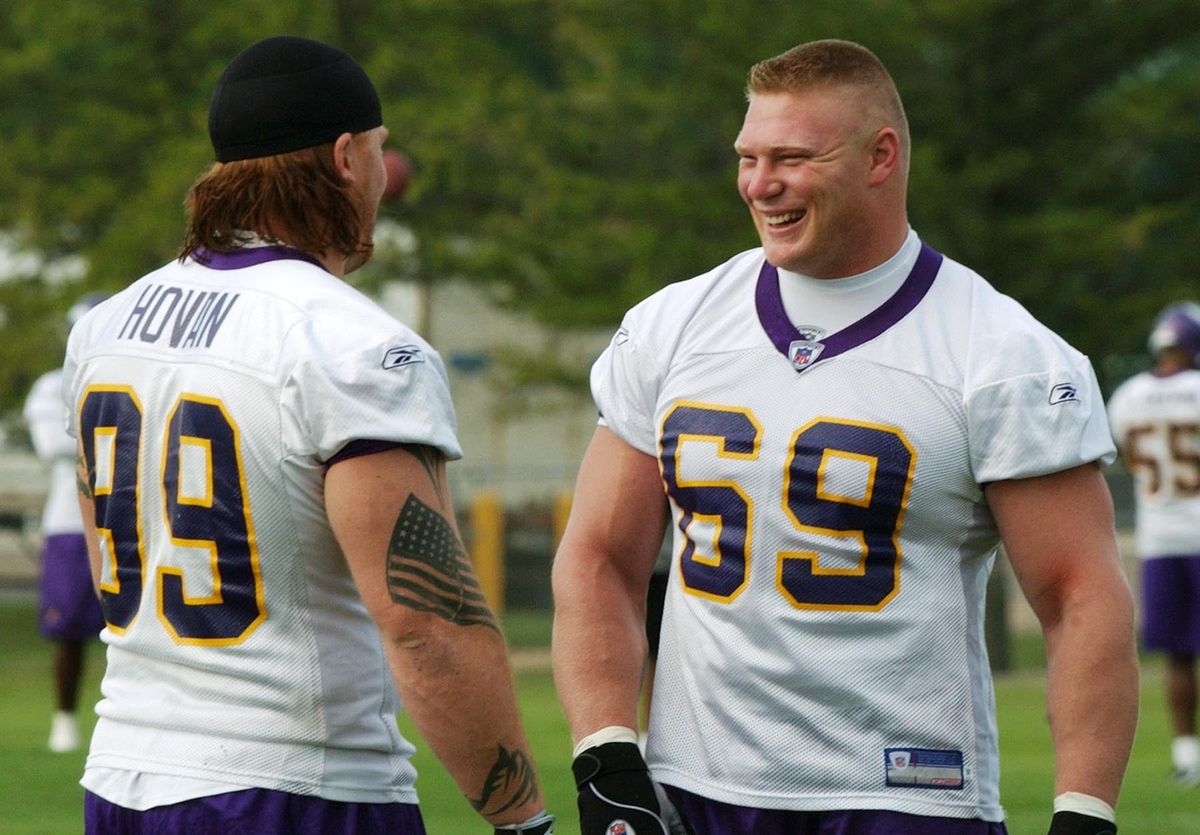 Photo of Lesnar (right) and Chris Hovan by Jim Mone/ [object Object] .