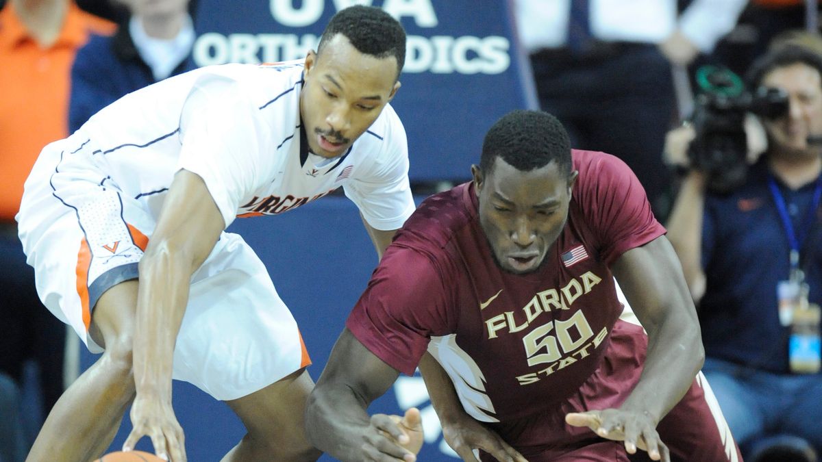 Former Florida State Center Michael Ojo (right) died of a heart attack in Serbia in August after recovering from COVID-19.
