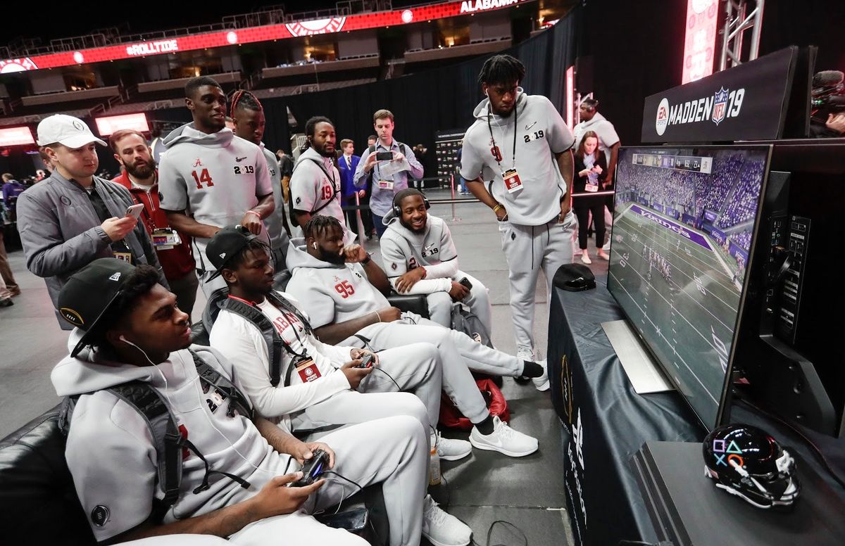 Members of the Crimson Tide sit down around a game Madden in 2019, in the absence of an EA Sports college football release to play.