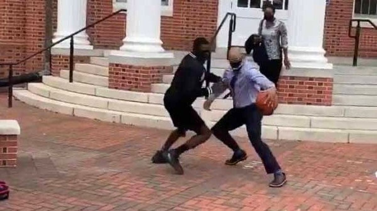 Virginia State President Makola Abdullah, formal wear and all, nonetheless lights up this poor student.