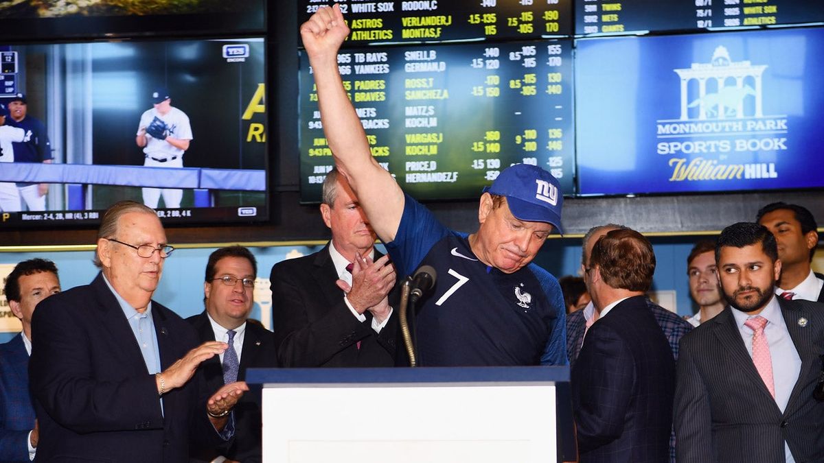 Raymond Lesniak celebrates at a news conference before the start of sports gambling in New Jersey.