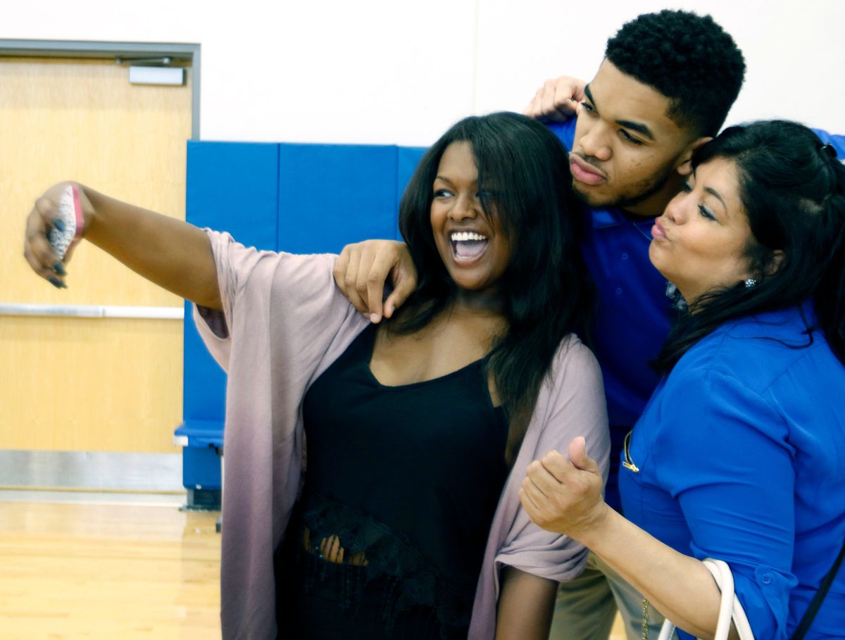 Jacqueline Cruz, right, is shown with her son Karl Anthony Towns and his girlfriend India Gentry before the 2015 NBA Draft. Cruz died on Monday due to complications from COVID-19.