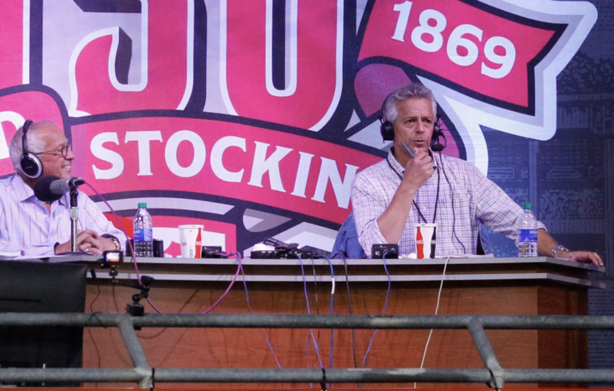 Thom Brennaman calls a game with his father, Marty Brennaman, in 2019.