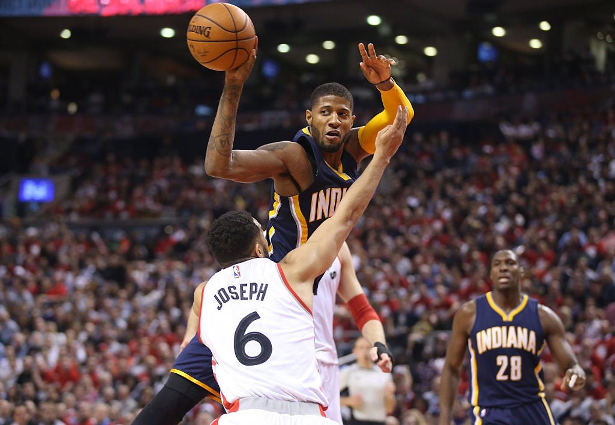 Paul George passes over Cory Joseph in Game One of the Eastern Conference Quarterfinals. Via  [object Object] .