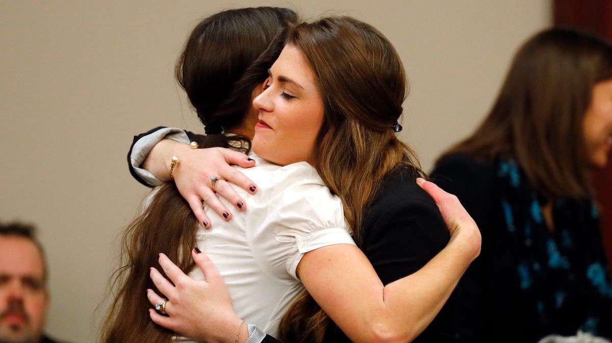 Rachael Denhollander, left, hugs Sterling Riethman after Larry Nassar’s plea hearing in Lansing, Mich in Nov. 2017