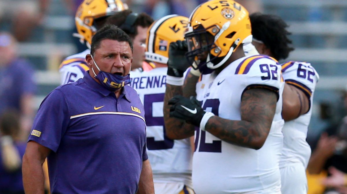 Here we see LSU head coach, Ed Orgeron, yelling directly into the face of an open-mouthed player during the midst of a global pandemic.