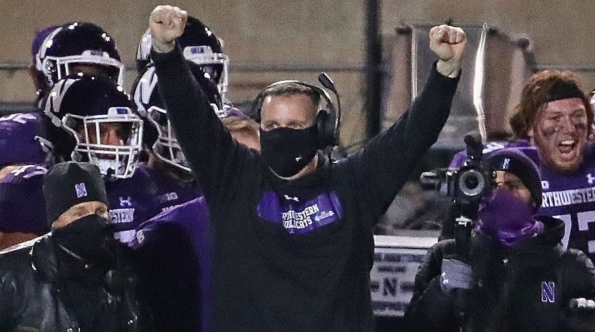 Northwestern coach Pat Fitzgerald celebrates his team’s 17-7 win over Wisconsin on Saturday.