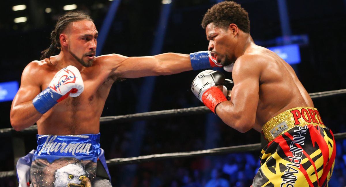 Keith Thurman (left) uses his length to connect with Shawn Porter. (Photo credit: Ed Mullholland/ [object Object] )