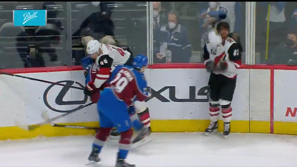 Colorado’s Nathan MacKinnon tosses the Coyote Connor Garland’s helmet at his head last night.