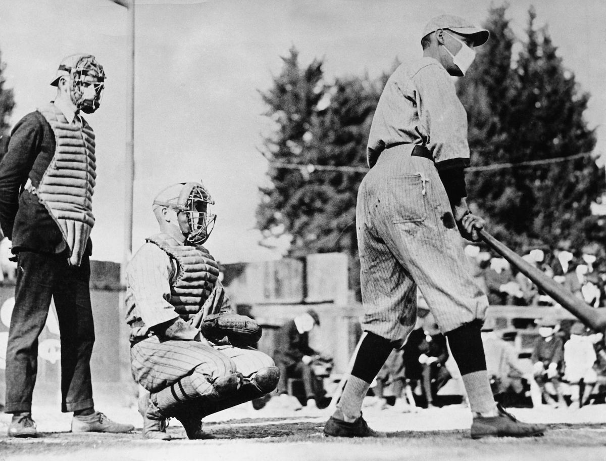 Batter steps in while wearing a mask during the 1918 Spanish flu pandemic.