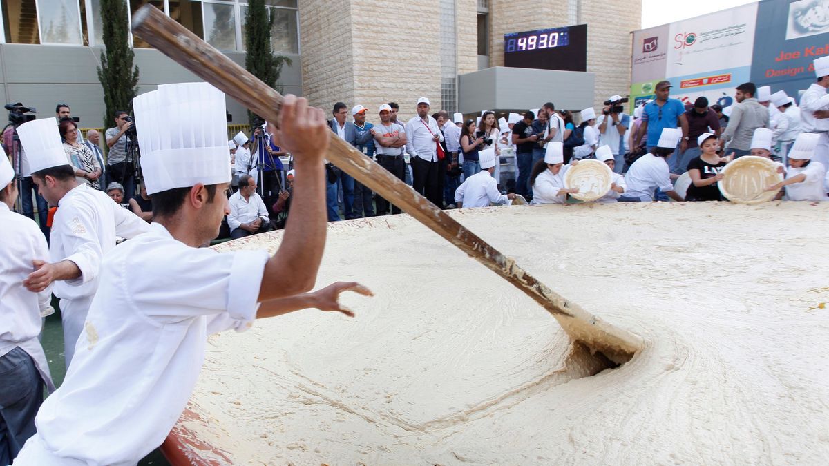 Photo of Lebanese chefs preparing 22,000 pounds of hummus via Hussein Malla/ [object Object]