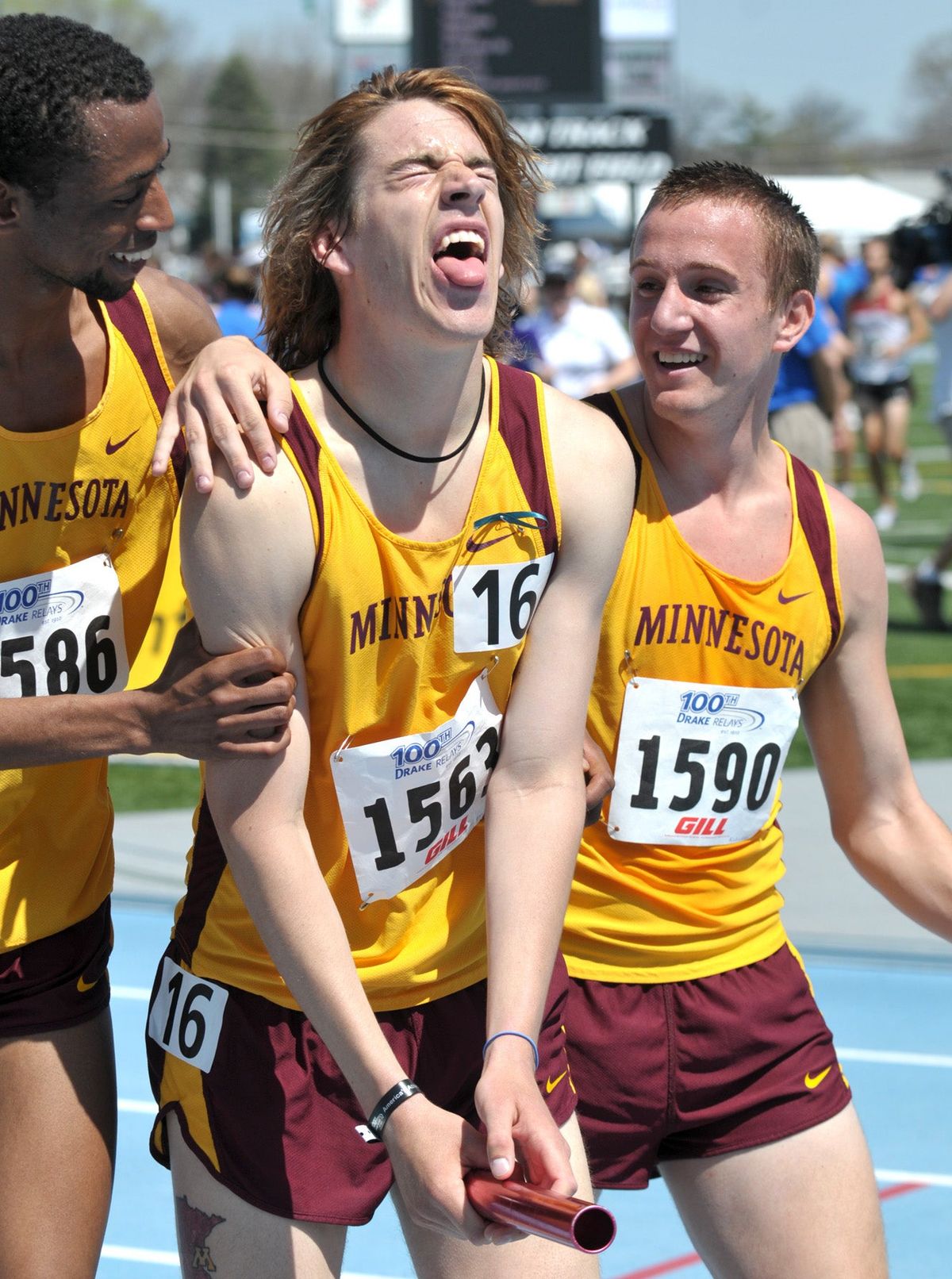 Hassan Mead (left) celebrates with University of Minnesota teammates after winning a race at the Drake Relays, 2009. Photo credit: Steve Pope/ [object Object]