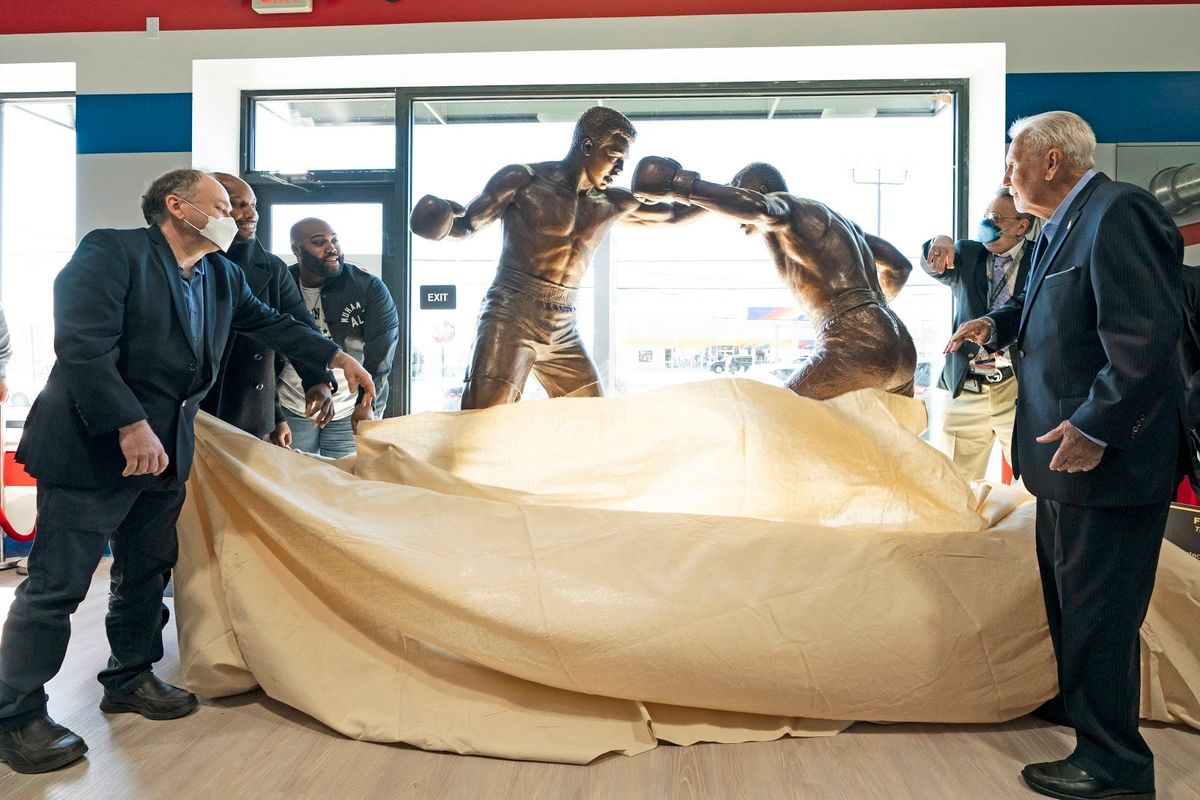 A statue of boxers Joe Frazier, center right, and Muhammad Ali, center left, is unveiled on the 50th anniversary their World Heavyweight Champion fight in Feasterville, Pa., on Monday.