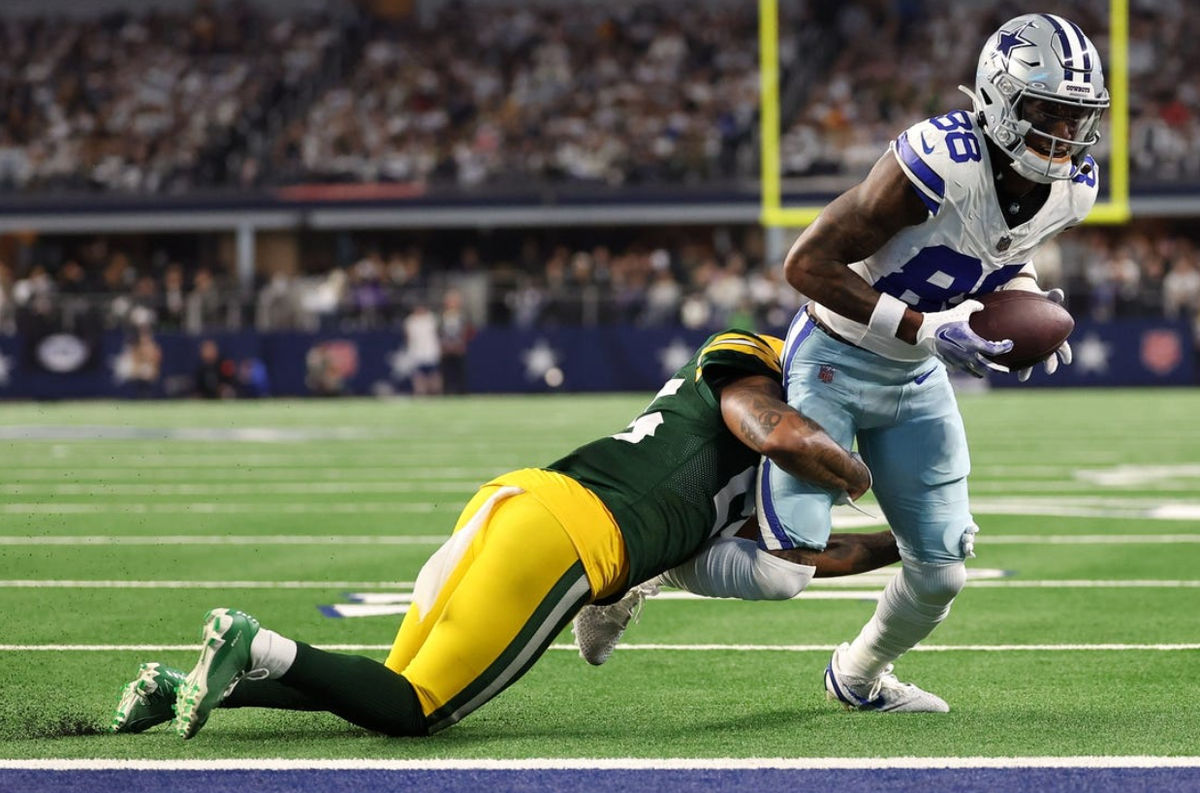 Jan 14, 2024; Arlington, Texas, USA; Dallas Cowboys wide receiver CeeDee Lamb (88) makes a catch against Green Bay Packers cornerback Corey Ballentine (35) in the first half of the 2024 NFC wild card game. Mandatory Credit: Kevin Jairaj-USA TODAY Sports