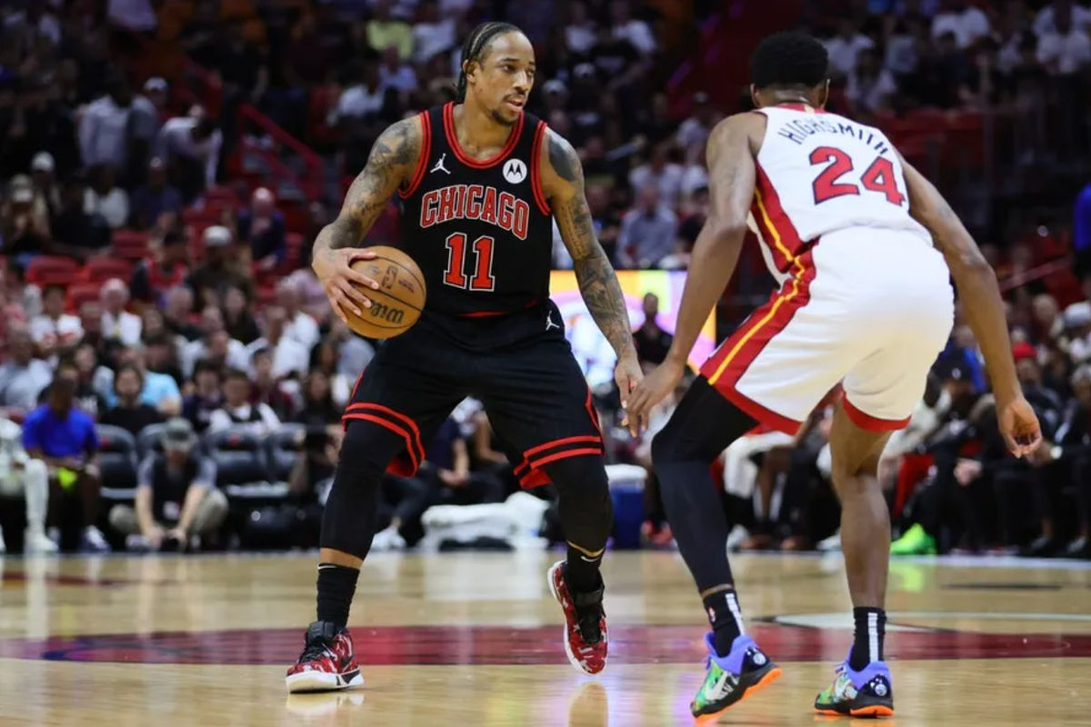 Apr 19, 2024; Miami, Florida, USA; Chicago Bulls forward DeMar DeRozan (11) dribbles the basketball as Miami Heat forward Haywood Highsmith (24) defends in the first quarter during a play-in game of the 2024 NBA playoffs at Kaseya Center. Mandatory Credit: Sam Navarro-USA TODAY Sports