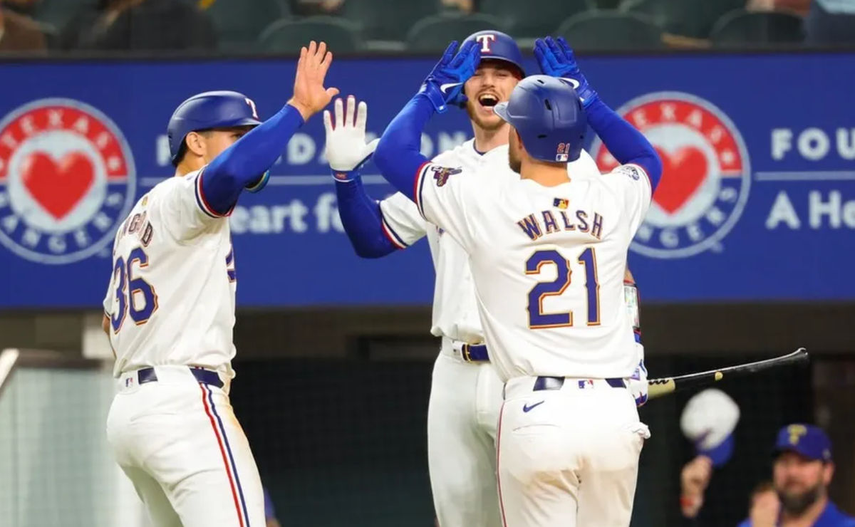 Mar 30, 2024; Arlington, Texas, USA; Texas Rangers first baseman Jared Walsh (21) celebrates with Texas Rangers designated hitter Wyatt Langford (36) and Texas Rangers catcher Jonah Heim (28) after hitting a two-run home run during the second inning against the Chicago Cubs at Globe Life Field. credits: Kevin Jairaj-USA TODAY Sports