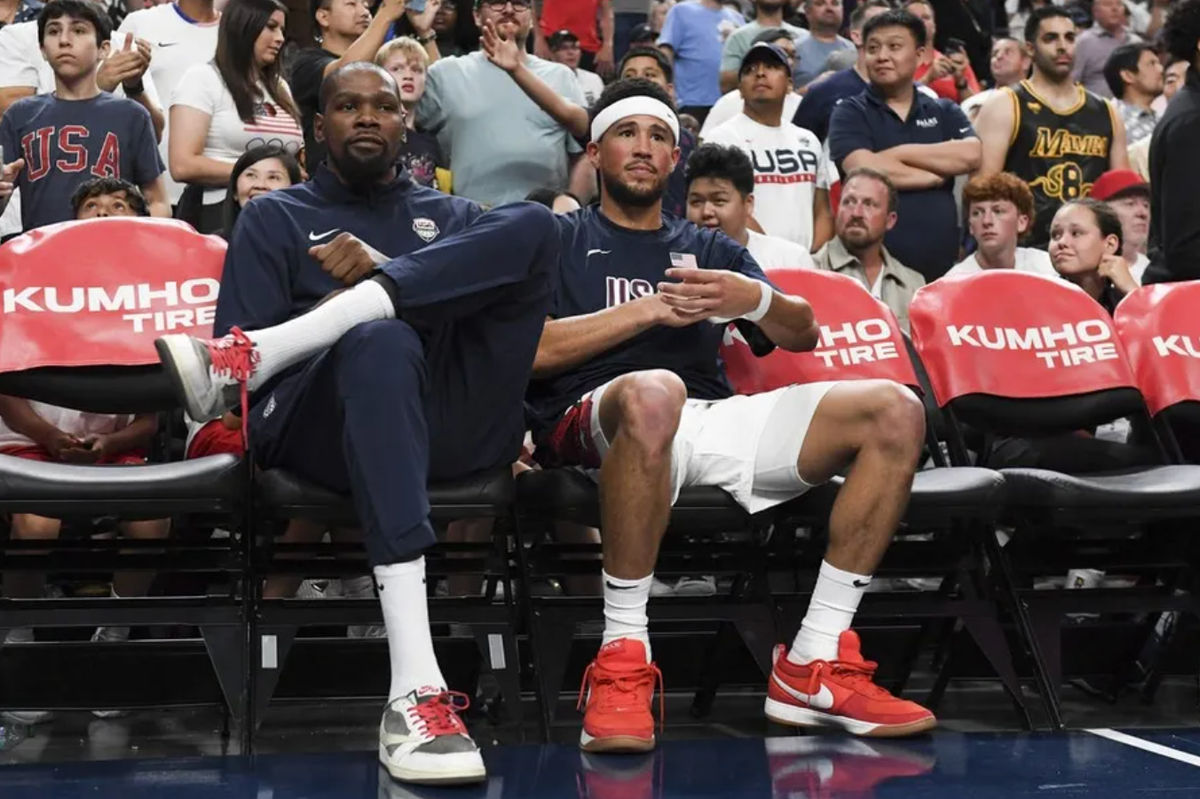 Jul 10, 2024; Las Vegas, Nevada, USA; USA forward Kevin Durant (7) and guard Devin Booker (15) look on from the bench during the fourth quarter against Canada in the USA Basketball Showcase at T-Mobile Arena. Mandatory Credit: Candice Ward-USA TODAY Sports