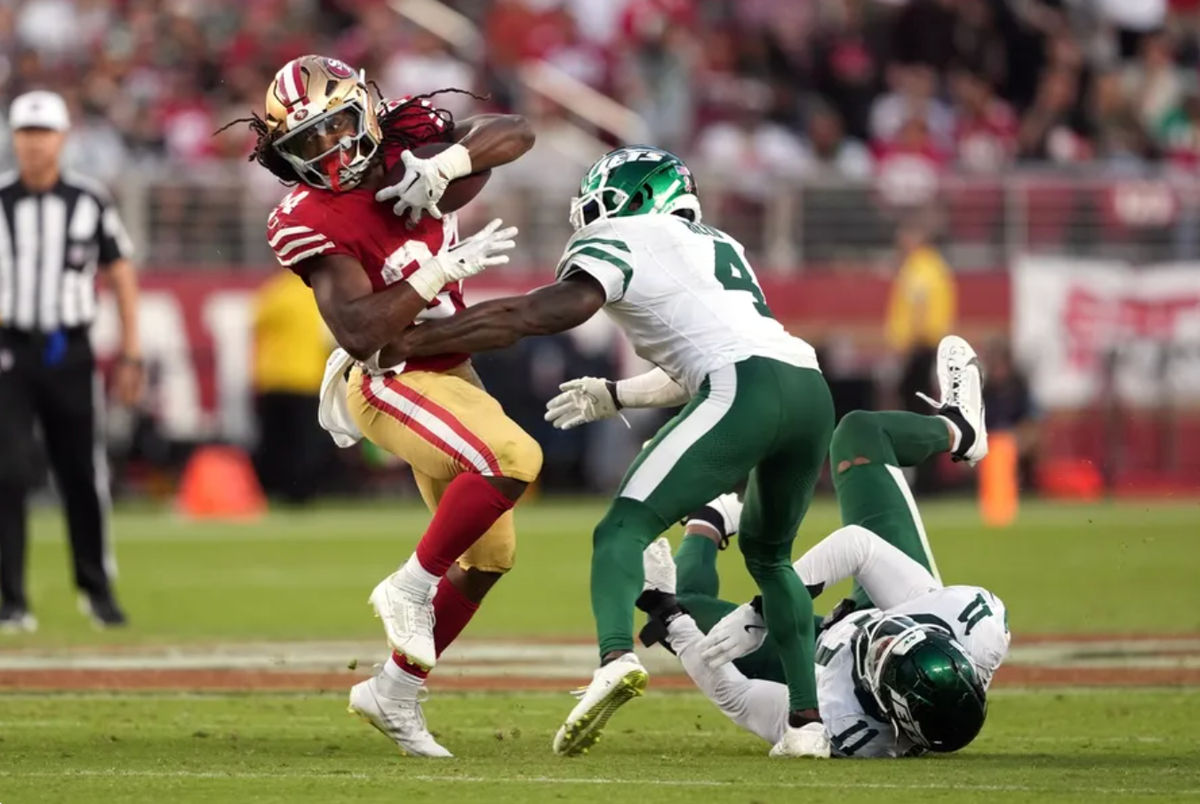 Sep 9, 2024; Santa Clara, California, USA; San Francisco 49ers running back Jordan Mason (left) carries the ball against New York Jets cornerback D.J. Reed (4) during the third quarter at Levi's Stadium. Mandatory Credit: Darren Yamashita-Imagn Images
