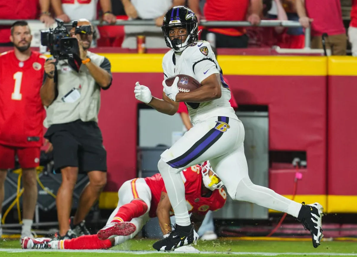 Kansas City, Missouri, USA; Baltimore Ravens tight end Isaiah Likely (80) scores a touchdown against Kansas City Chiefs safety Bryan Cook (6) during the second half at GEHA Field at Arrowhead Stadium. Mandatory Credit: Jay Biggerstaff-Imagn Images