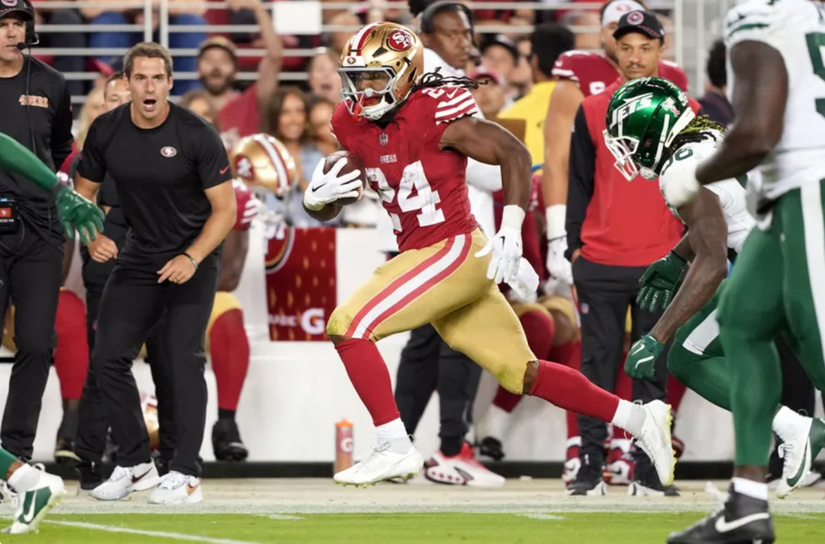 Sep 9, 2024; Santa Clara, California, USA; San Francisco 49ers running back Jordan Mason (24) carries the ball against New York Jets linebacker Quincy Williams (obscured right) during the fourth quarter at Levi's Stadium. Mandatory Credit: Darren Yamashita-Imagn Images